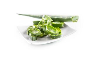 Slices of aloe vera with gel on white background photo