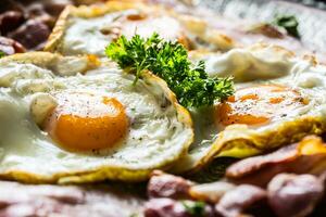 Close-up roasted bacon and egg with herbs. photo