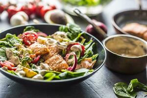 Salmon steak in a bowl with fresh salad photo