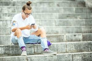 Young teenage girl with headphones enjoying with good music. Modern young woman with cellphone photo