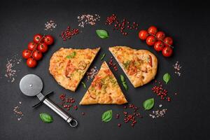 Delicious oven fresh flatbread pizza with cheese, tomatoes, sausage, salt and spices photo