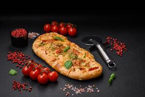 Delicious oven fresh flatbread pizza with cheese, tomatoes, sausage, salt and spices photo