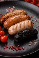 Delicious juicy sausages of several varieties grilled with salt, spices and herbs photo