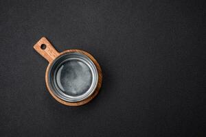 Empty round ceramic bowl on a wooden cutting board in brown color photo
