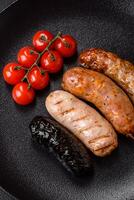 Delicious juicy sausages of several varieties grilled with salt, spices and herbs photo