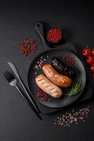 Delicious juicy sausages of several varieties grilled with salt, spices and herbs photo