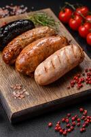 Delicious juicy sausages of several varieties grilled with salt, spices and herbs photo