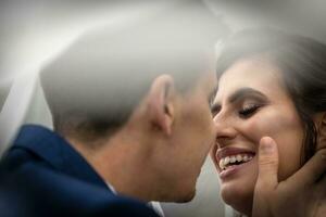 Detail of just married husband and wife right before giving each other a kiss photo