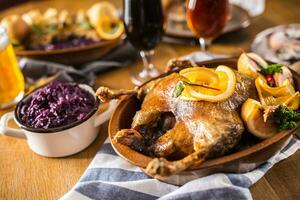 Roasted christmas duck red cabbage dumplings liver draft beer and baked buns. photo