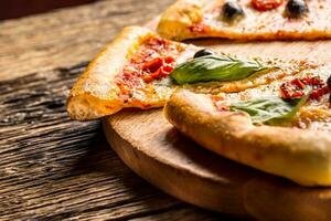 Pizza. Tasty fresh italian pizza served on old wooden table photo