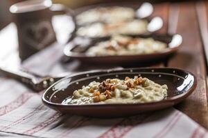 Traditional slovakian food Halusky with fried bacon and decoration photo