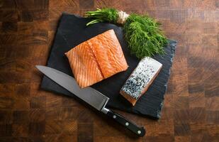 Raw salmon fillet with dill lemon olive oil salt and pepper photo