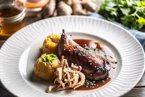 Slow roasted chicken leg on honey and ginger, mashed potatoes with onion and coriander - Top of view photo