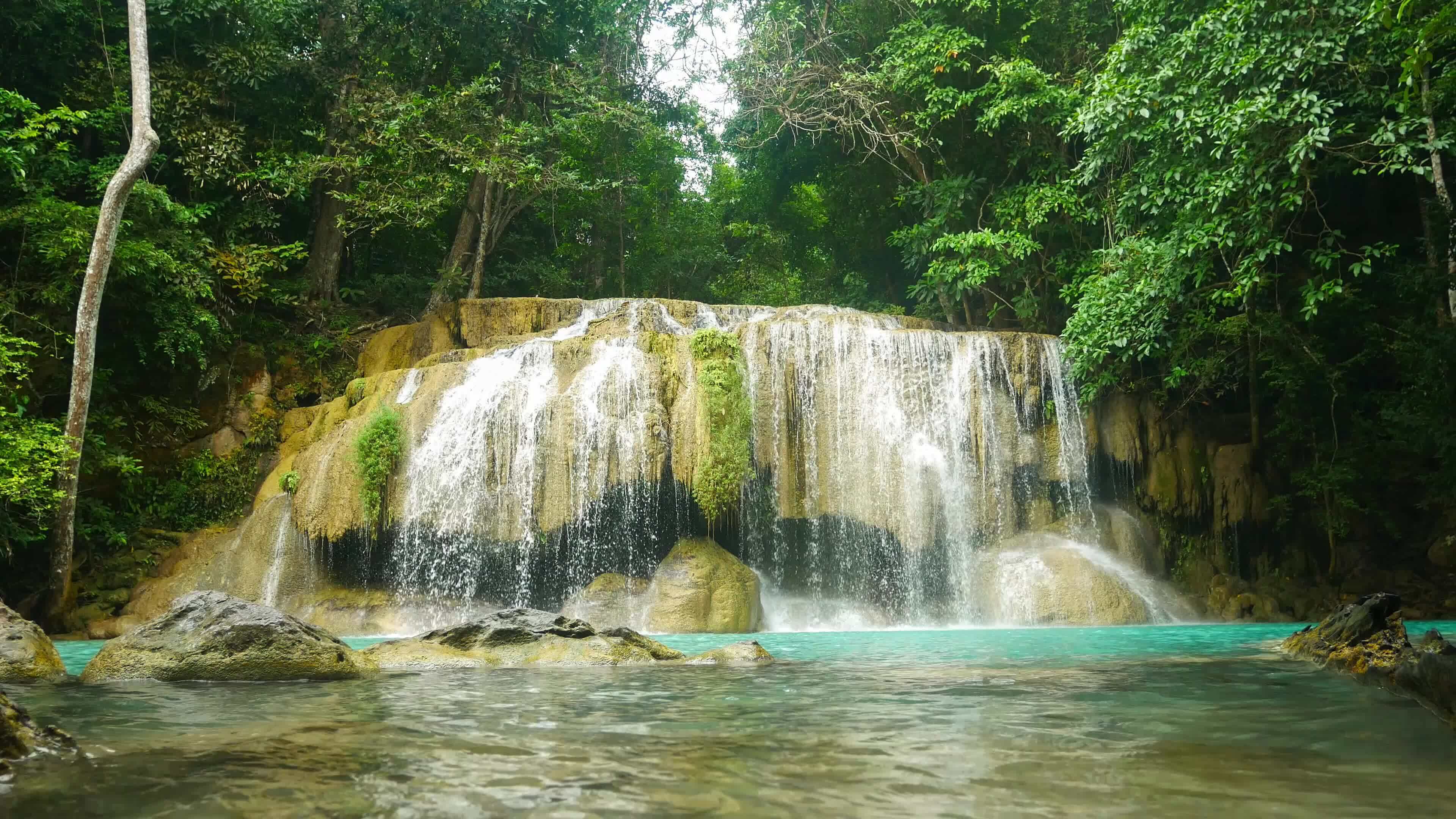 Natural scenery of beautiful Erawan waterfalls in a tropical rainforest ...