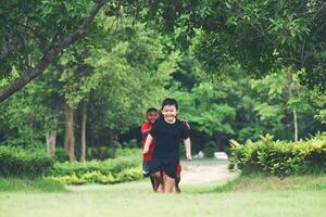 Group Of Young Children Running and playing in the park photo