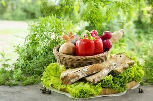 Rustic bread and vibrant veggies on wooden board photo