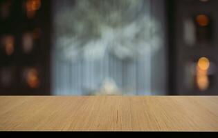 Empty wooden table in front of abstract blurred background of coffee shop . can be used for display or montage your products.Mock up for display of product photo