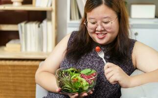 Asian Overweight woman dieting Weight loss eating fresh fresh homemade salad healthy eating concept Obese Woman with weight diet lifestyle. photo