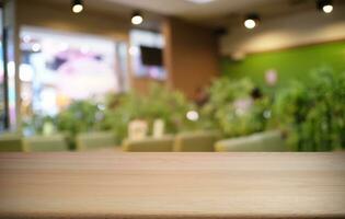 Empty dark wooden table in front of abstract blurred bokeh background of restaurant . can be used for display or montage your products.Mock up for space. photo