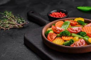Colorful mix of fresh and steamed veggies cherry tomatoes, broccoli, and carrots photo