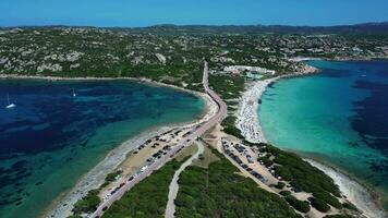 Aerial backward view of isthmus of sea with road and beach in Sardinia video