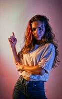 photo of beautiful woman with red and pink lighting and backdrop , generative AI