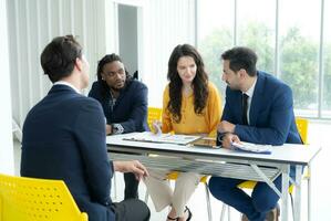 Job interview concept. Diverse hr team doing job interview with a man in business office. Human resources team interviewing a potential job candidate. Hiring, employment, and recruitment concept. photo