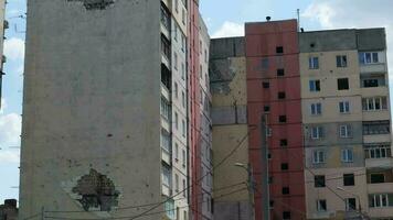 Traces of an artillery shell hitting a multi-storey residential building. Part of the building was destroyed by the shock wave and shrapnel. Shelling at home. video