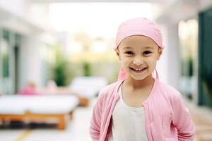 Happy cancer patient. Smiling girl after chemotherapy treatment at hospital oncology department. Leukemia cancer recovery. Cancer survivor. Portrait smiling bald cute girl with a pink headscarf. photo