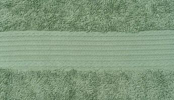 Texture of a green terry cotton towel, canvas. Macro photo