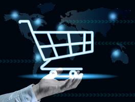 Male hand and a shopping cart icon, concept of starting a sale, online shopping, increasing business profits during seasonal discounts. photo