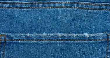Fragment of the back pocket of blue jeans photo