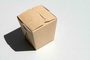 A box of craft cardboard for takeaway food. Closed food container isolated, top view photo