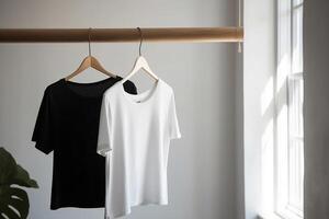 Black and white T-shirt hanging on a hanger. photo