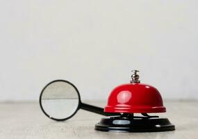 Metallic red bell to call staff on a white background, copy space photo