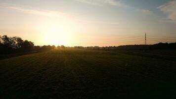 The sun setting over a grass field video