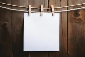 White paper sheets hang on a string with a clothespin. photo