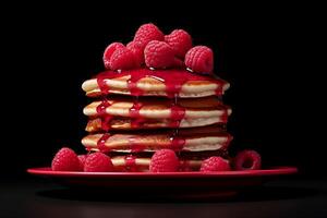 A stack of pancakes with raspberries and syrup. photo