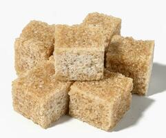 Cane sugar cubes on white background photo