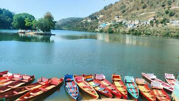 a row of colorful boats in the lake photo