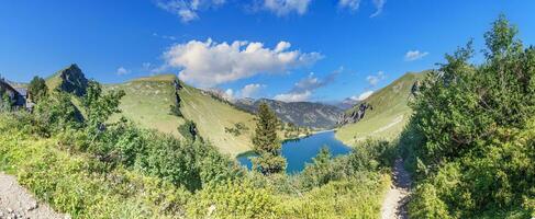 Panoramic view over the mountains on the Three Lakes Route in the Tannheimer Valleyi n summer photo