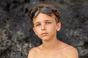 funny portrait of young shirtless man wearing sunglasses in an exotic beach photo