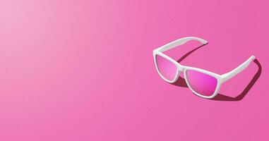 Banner of pink sunglasses over pink background and copy space. Studio shot. photo