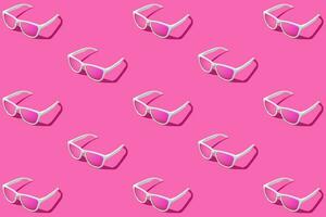 Pattern of pink sunglasses with pink gradient background. Studio shot. photo