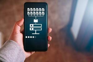 Woman hand showing data host server storage on smartphone screen. Icon for information exchange and transfer concept. photo