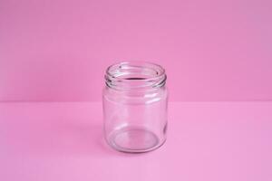 1 empty jar, no lid, with a pink scene, close up. photo