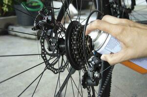 Bicycle gear lubricant spray to prevent rust and reduce humidity. photo