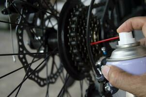 Bicycle gear lubricant spray to prevent rust and reduce humidity. photo