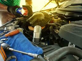 Technician repairing the engine, checking the engine oil change photo