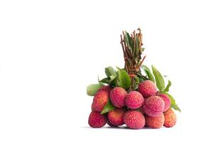 a bunch of lychees on white background. It is a fruit with rough skin. They are reddish pink or bright red. seed coat Milky white that is full of water. The meat gives a sweet and sour taste. photo